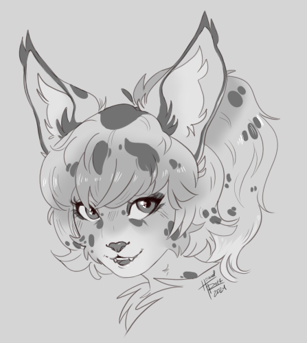 A serval cat heashot. She's looking at the viewer.