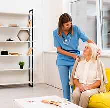 long-shot-nurse-helping-old-woman-with-her-coat.jpg