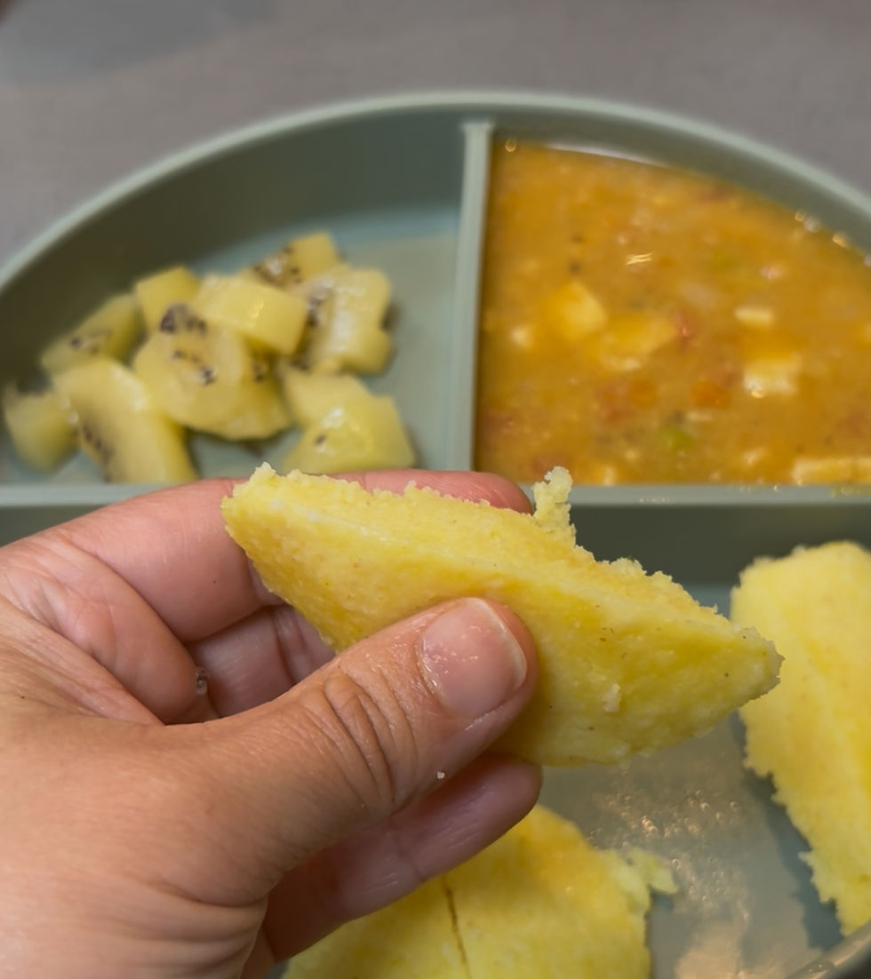 Soft moong dal idli held in hand showing squish-safe texture — baby led weaning finger food India