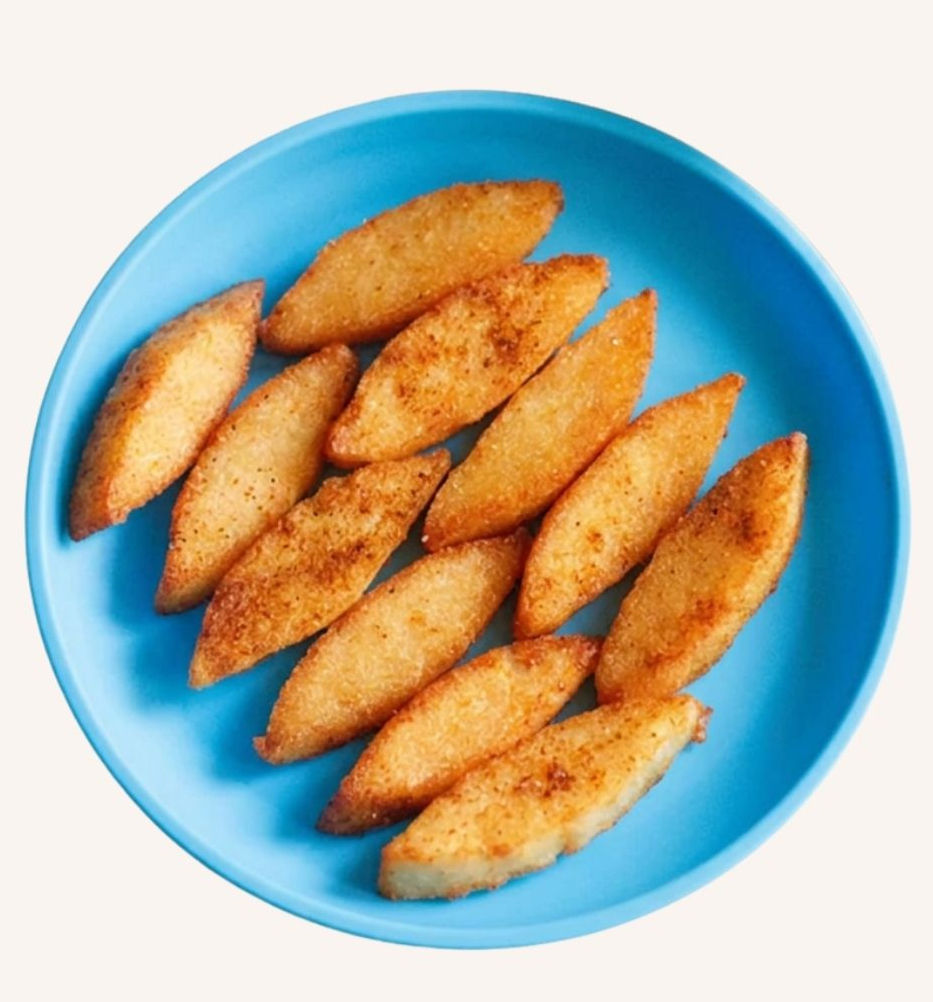Blue plate of golden fried idlis or steamed semolina cakes arranged on a blue coloured plate, with a crispy, appetizing look.