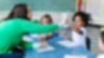Teacher giving a high five to a student.