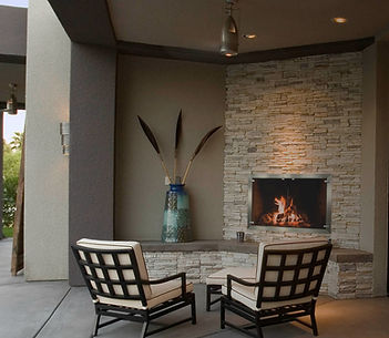 outdoor fireplace with cozy chairs