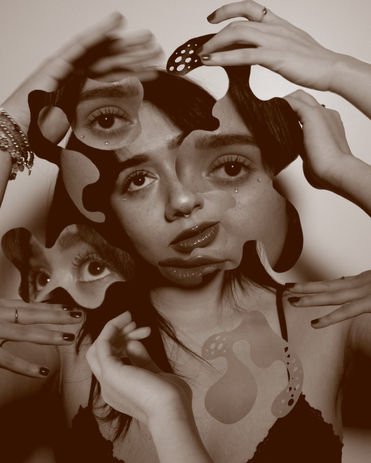 A gray monochromatic photo of a girl posing, with other images of her face collaged throughout the image.