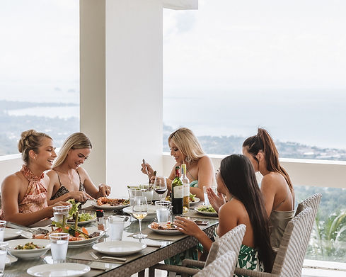 group of girls dining on terrace at a luxury Koh Samui villa with sea view
