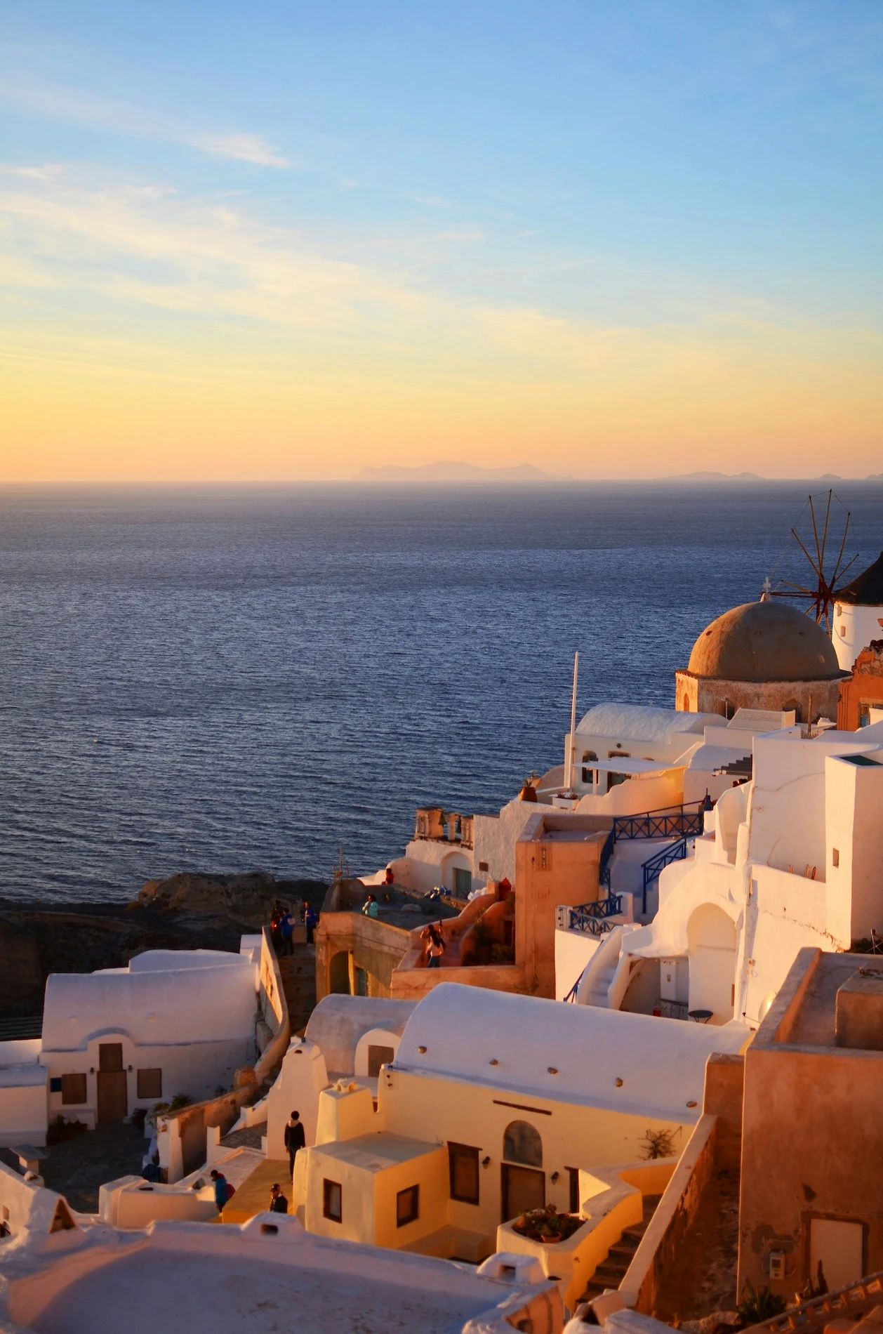 Buildings overlooking the Aegean Sea at sunset in Santorini, Greece