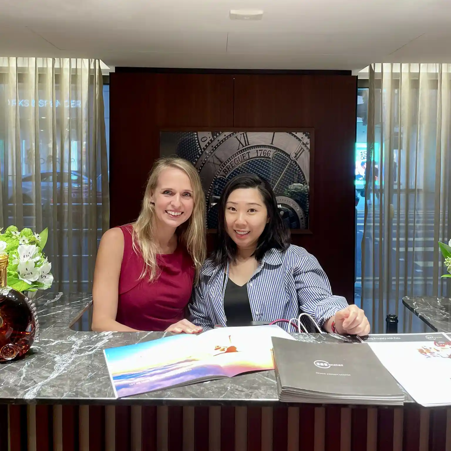 two women in front of a desk