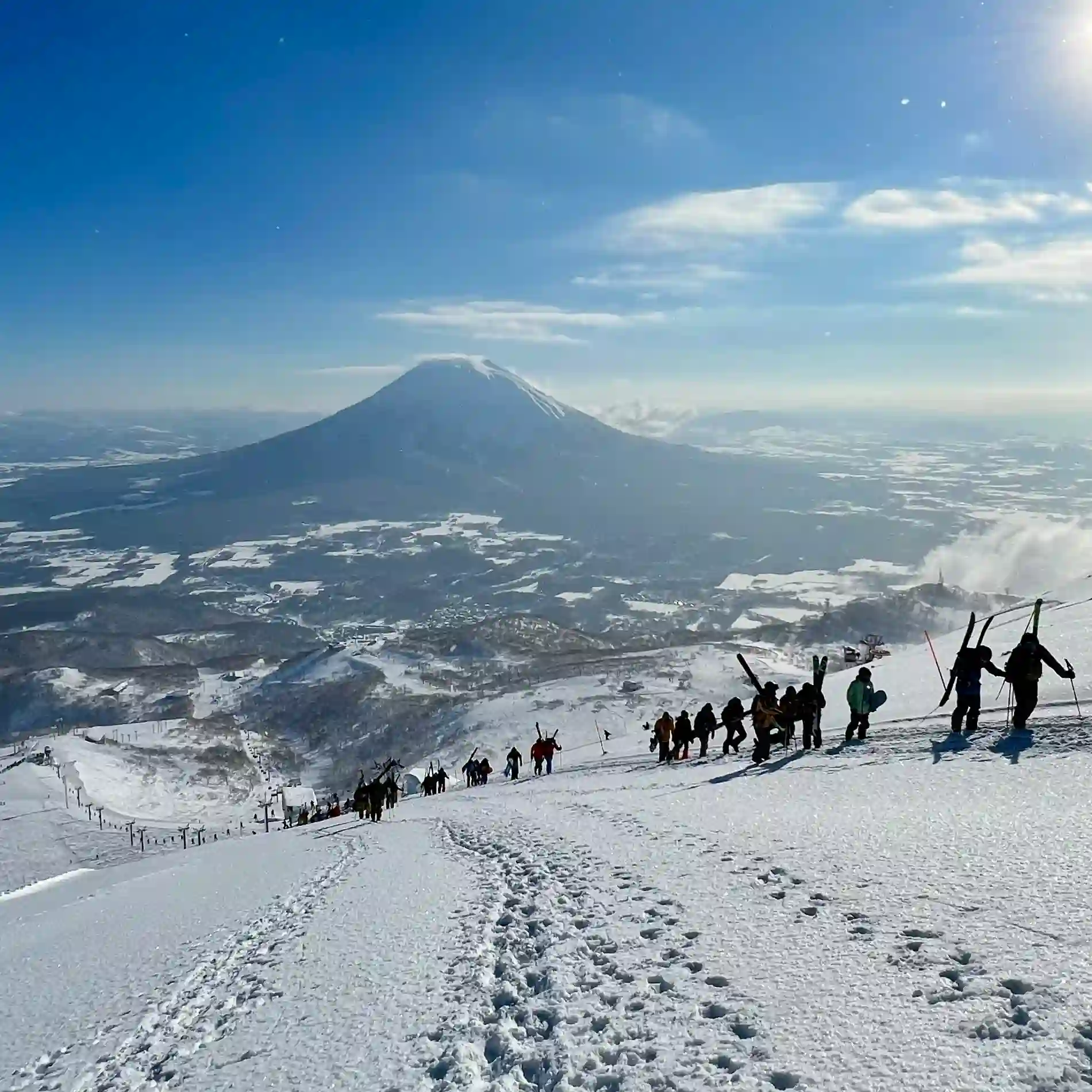  A group of skiers climbing ski slope by Mount Yotei in Japan