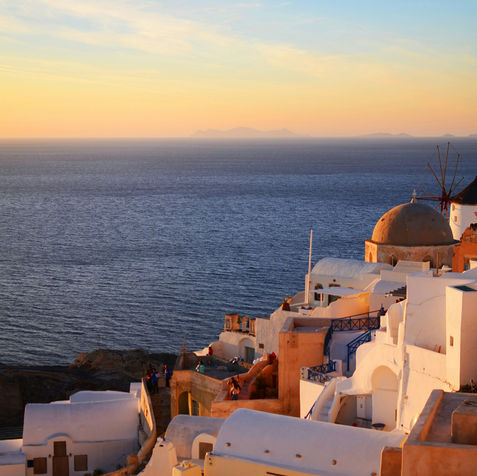 greek village overlooking the sea at sunset in Oia, Greece
