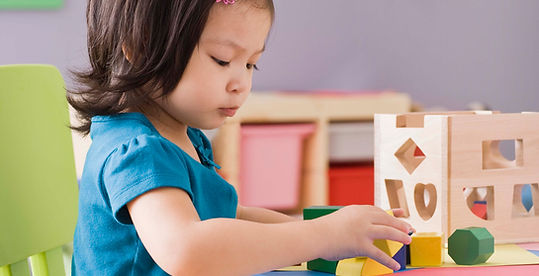 Girl playing with shape sorter