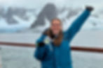 girl in a parka holding a medal in Antarctica