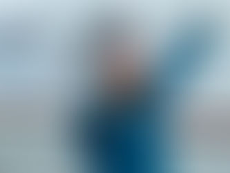 a girl stands in front of snow covered mountains smiling and holding a race medal