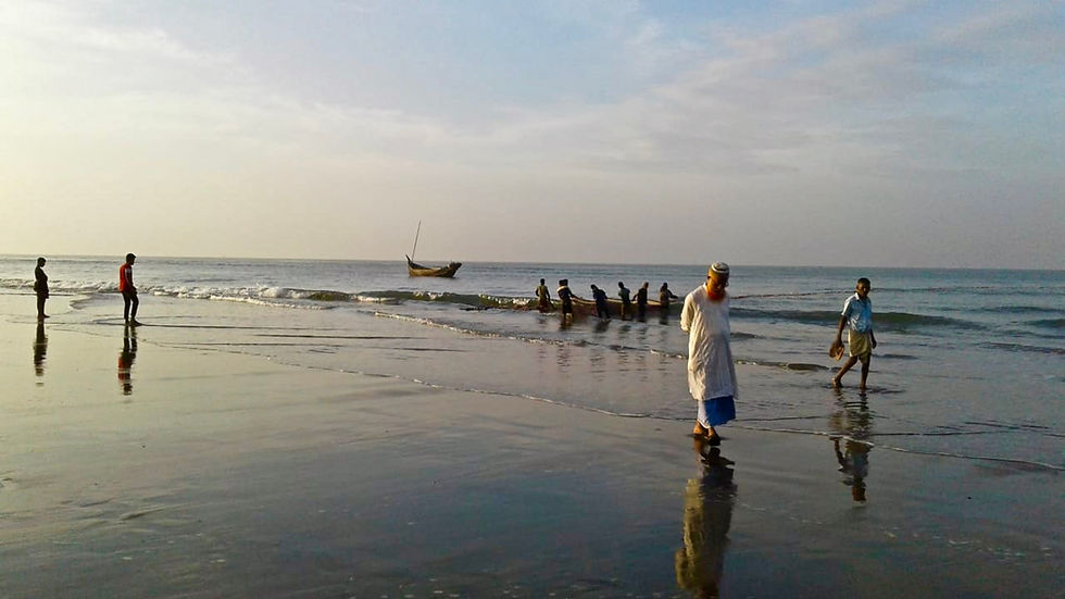People walking on the beach in Cox's Bazar, Bangladesh