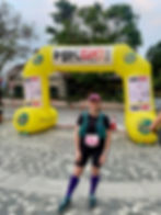 female runner smiling at the start line of the HK50 ultramarathon