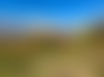 Female hiker with standing with her arms out in awe of giant mountains and fall leves