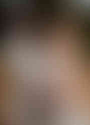 A blonde bride in a sweetheart fitted bodice lace gown and her new husband share a kiss