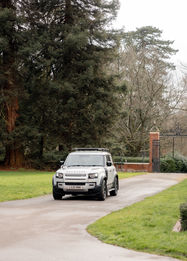 A defender drives down the road at Shaw House Newbury