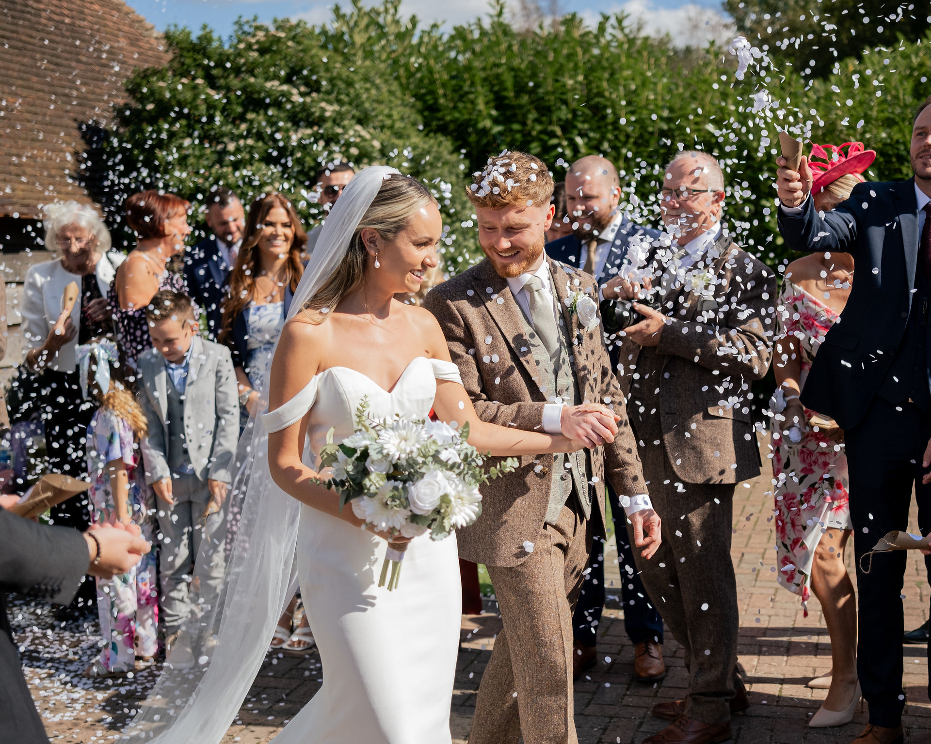 a couple walk through confetti at Skylark 