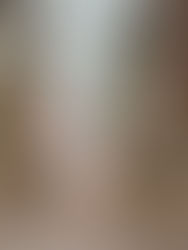 A couple in white kiss in the forest