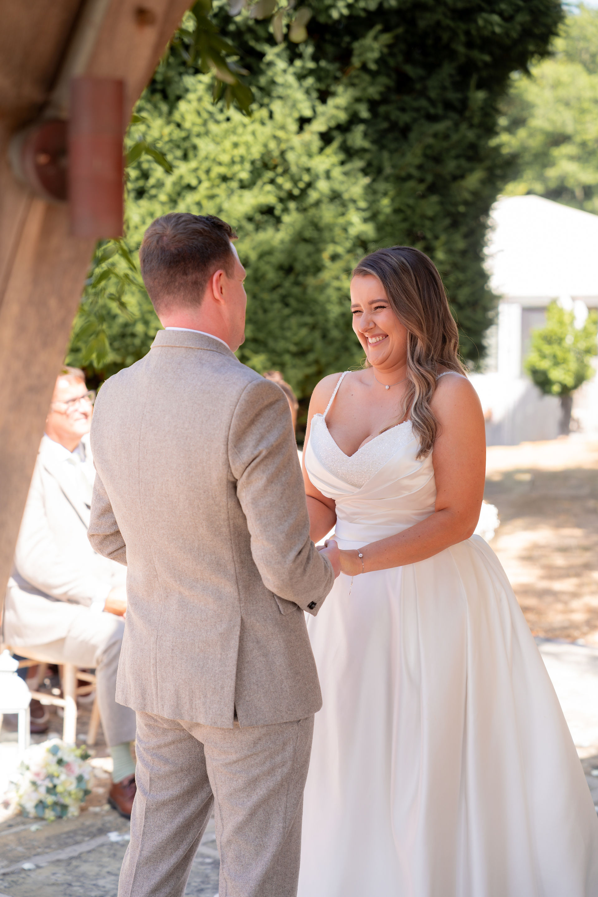 A bride smiles at her ceremony at Oakley Hall