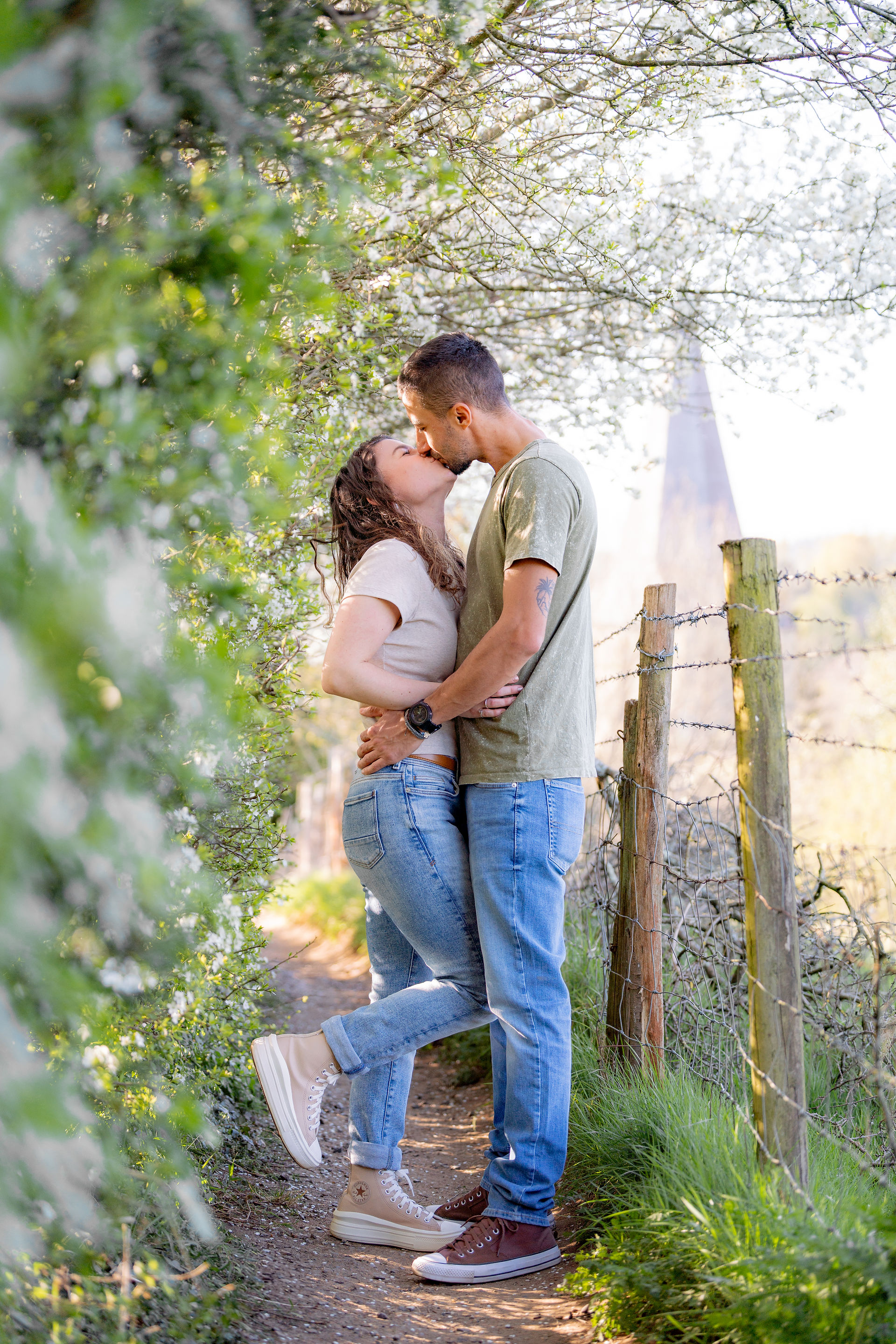A couple backlit with a church in the background