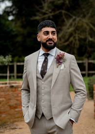 Ryan looks off into the distance in his grooms suit