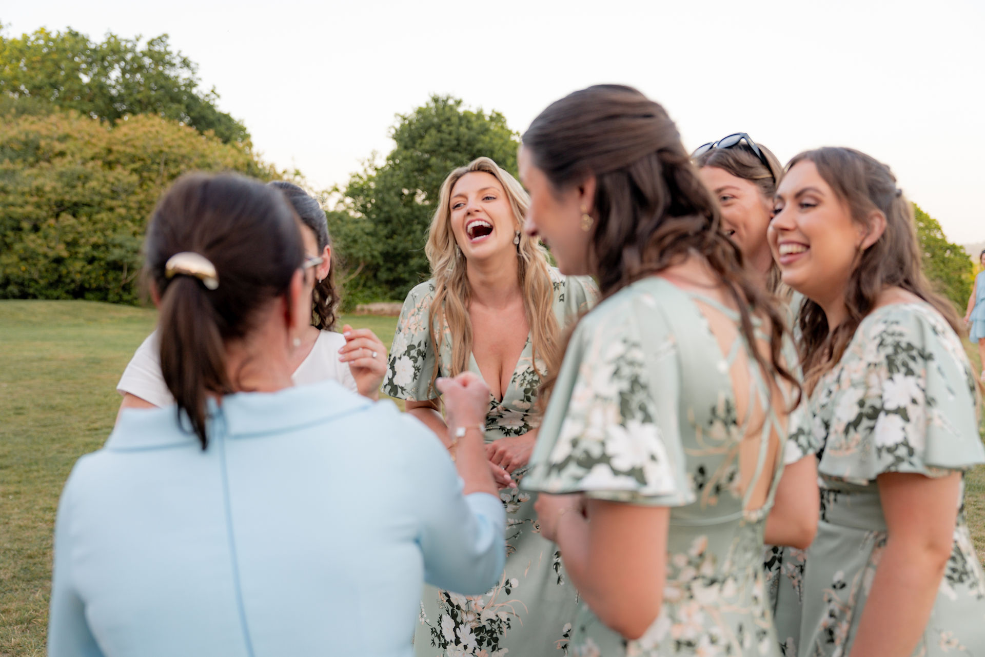 A bridesmaid laughs at Frensham Hall Weddings