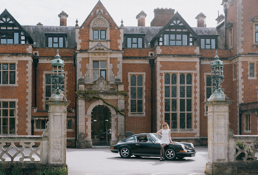 A girl sits on a 1970s Porsche 911 at Frensham Heights