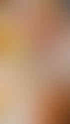 A woman drawing onto a watercolour painting