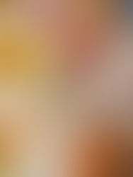 A womans hand draws on a watercolour painting of flowers