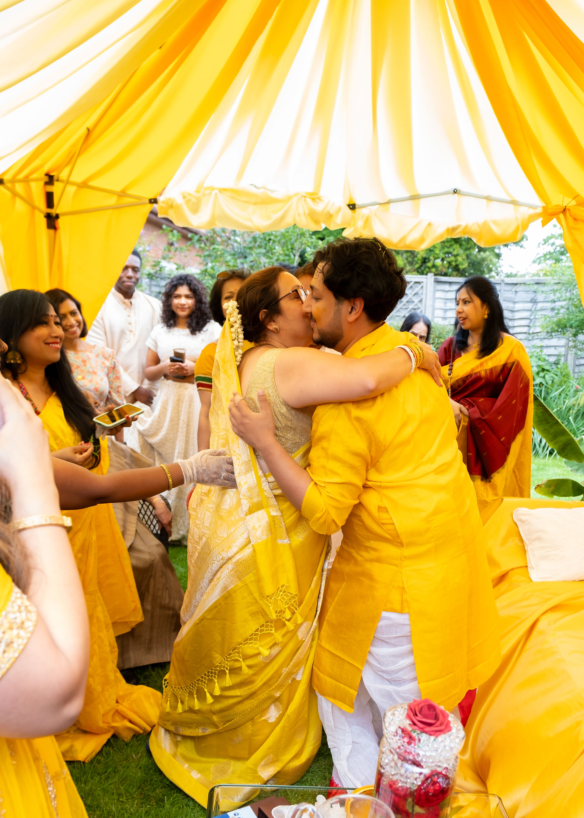 The groom and his mother hug at a Gaye holud 