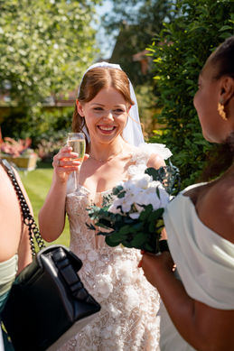 A candid of a bride laughing with her bridesmaids