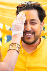 The groom gets turmeric smeared onto his face