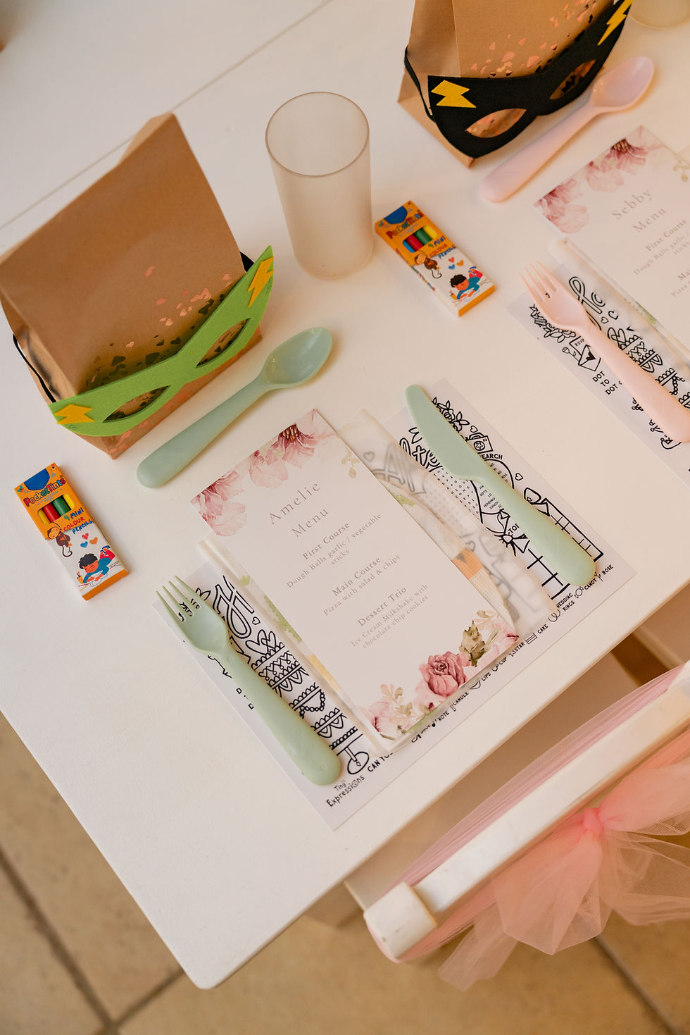A children's table setting at Rivervale barn complete with menu, plastic cutlery and party bag