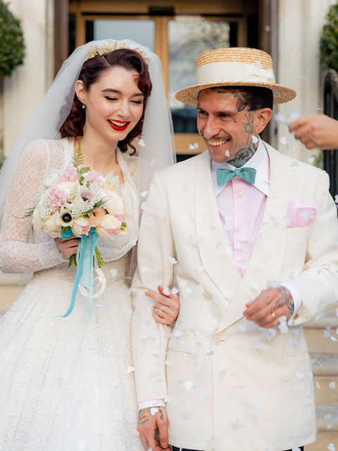 Bride and Groom in vintage inspired wedding outfits walk out of islington town hall