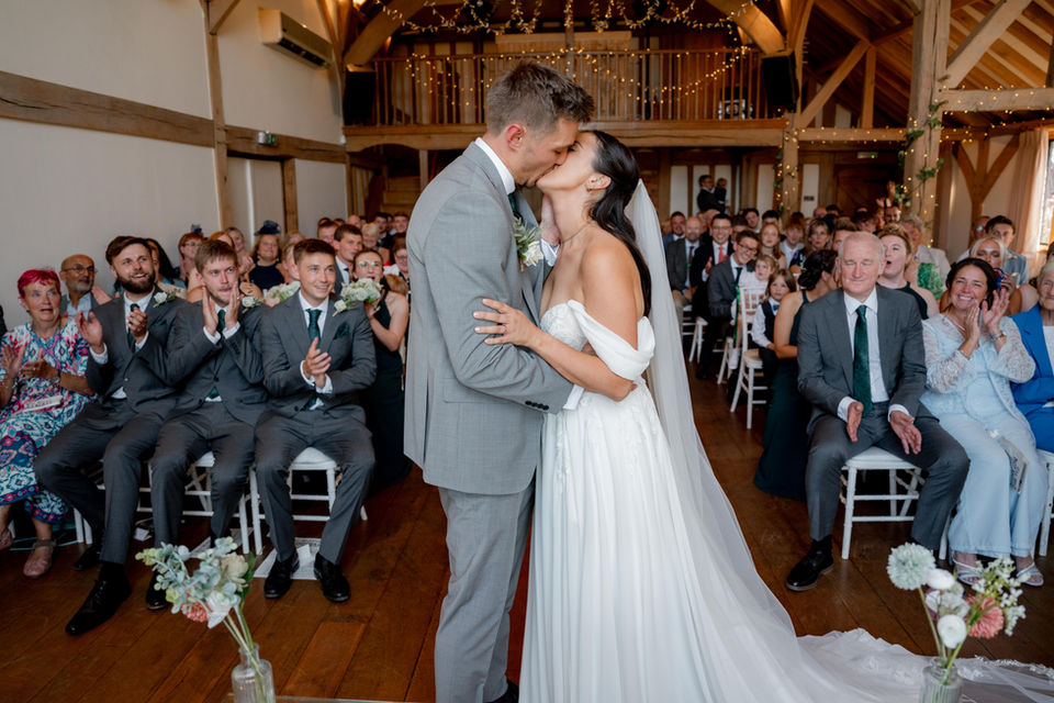 A bride and groom share a first kiss at Cain manor 