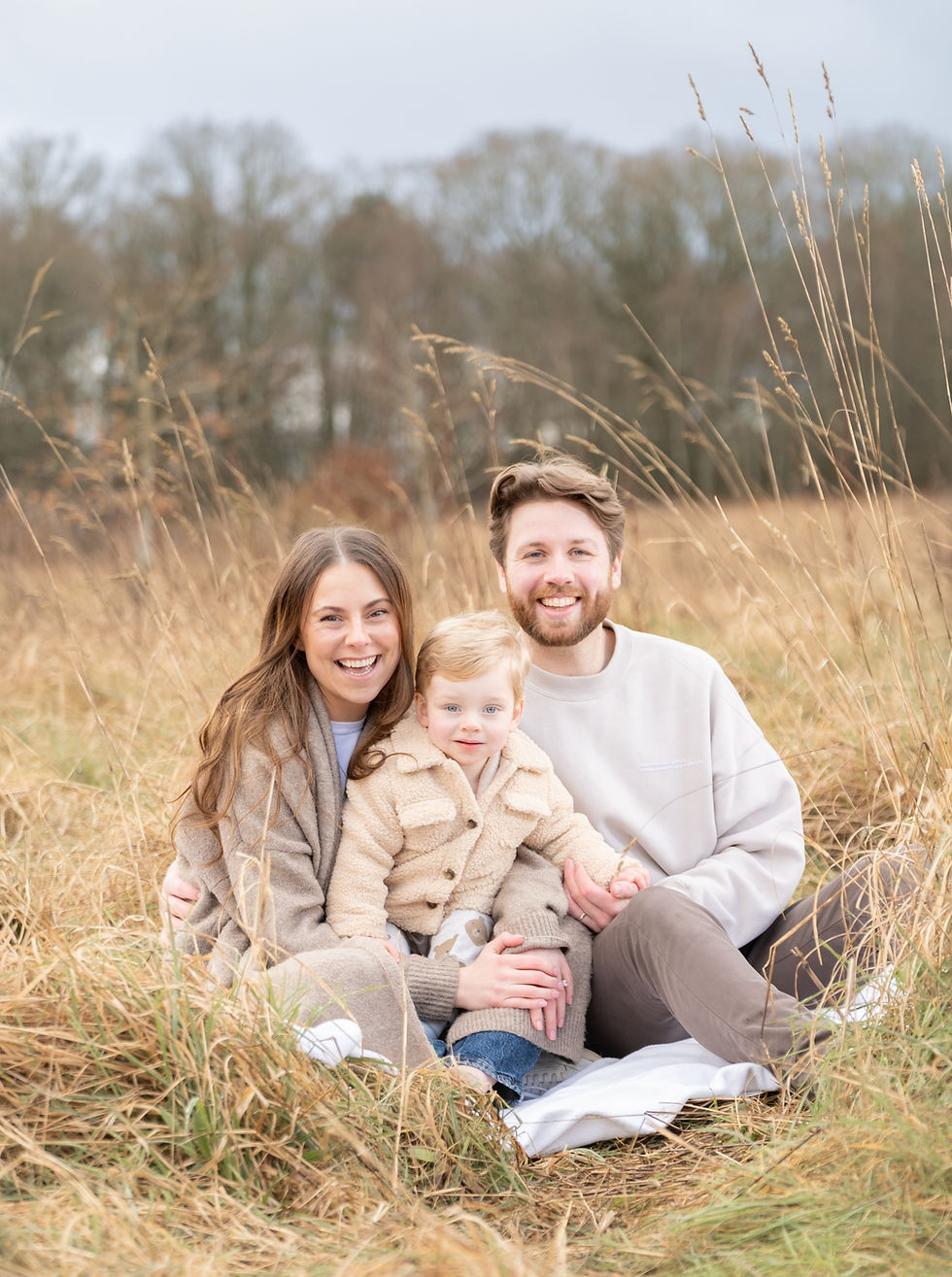 A family in a complimentary colour scheme in a field
