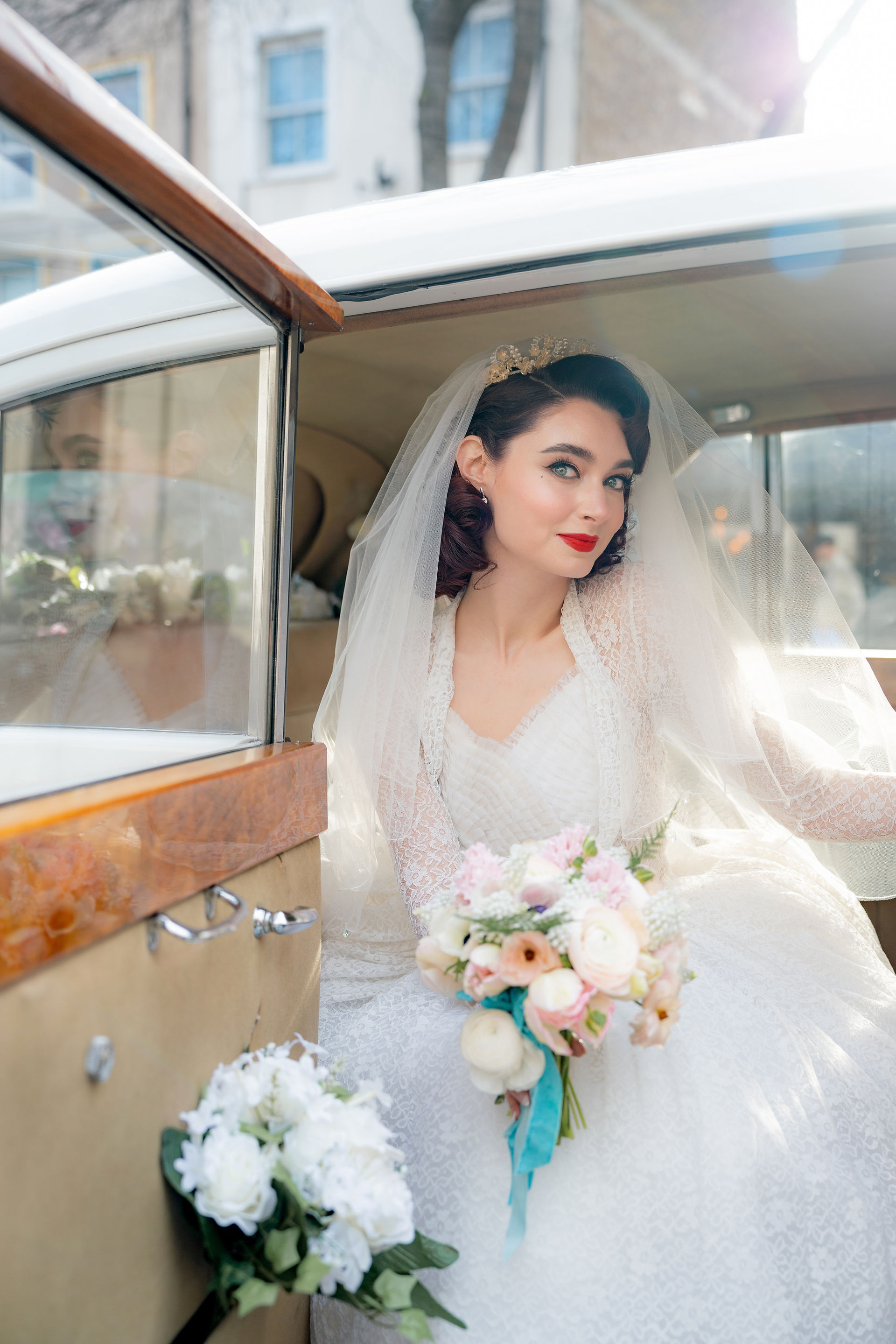 A vintage bride in a classic Rolls Royce
