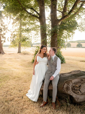 A bride and groom on a log at 