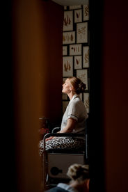 A bride sits in window light