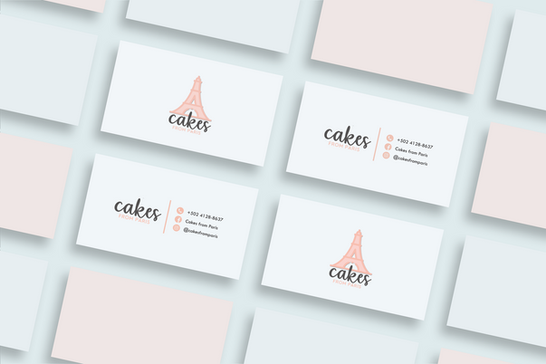 A set of elegant business cards with a pink Eiffel Tower logo and cursive text reading "cakes." Contact details are neatly displayed.