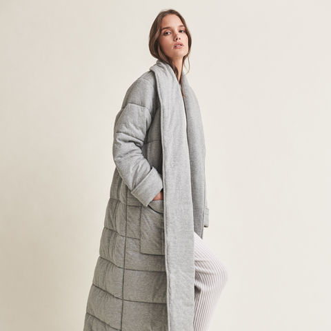 Woman wearing quilted cotton grey robe.
