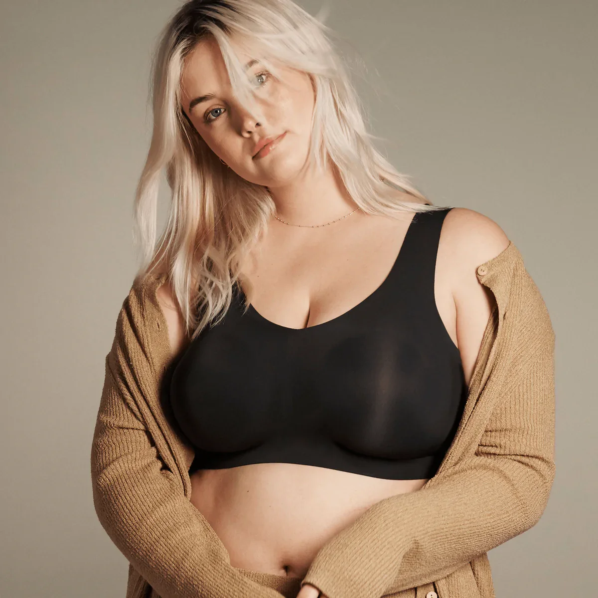 Woman wearing Evelyn & Bobby Bra in black, front view.