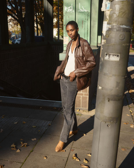 woman walking through a quiet street in early autumn sunlight