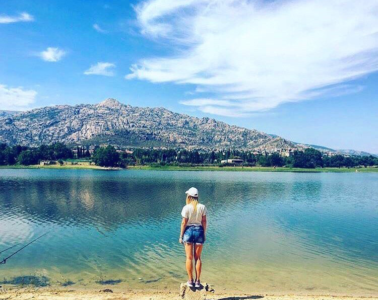 anna standing in front of a lake