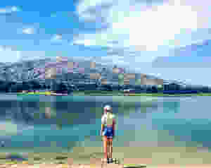 anna standing in front of a lake