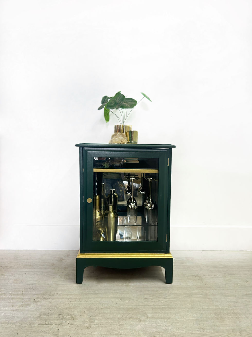 Thumbnail: Front view of vintage Stag drinks cabinet in Manor Green with glazed door and gold detailing