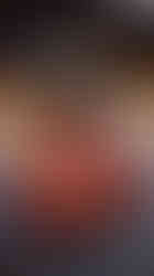 Grilled sausage skewers served on a black plate with mustard and ketchup, photographed at Shin Sen Gumi with a side dish in the background.