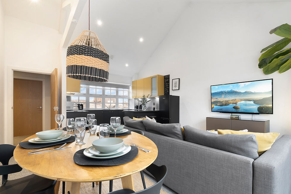 "Modern Foyer Green apartment featuring a spacious open-plan living room with stylish furniture and large windows, a high-spec kitchen with matt charcoal cabinets and stainless-steel appliances, a cosy bedroom with built-in wardrobes, a sleek bathroom with a rain shower,