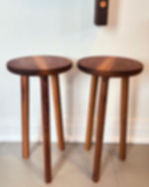 Pair of three-legged walnut side tables. 