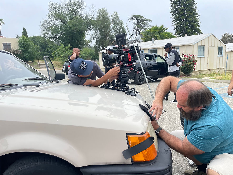 Jerry Mundy (on right) - Gaffer attaching car mount to 80’s prop car.